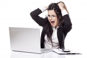 nervous young business woman at the desk with a laptop